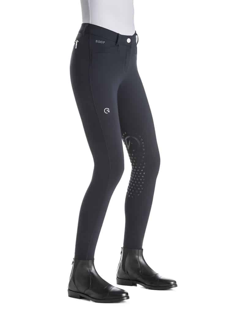 Black EGO7 breeches for equestrian riding paired with black riding boots on white background