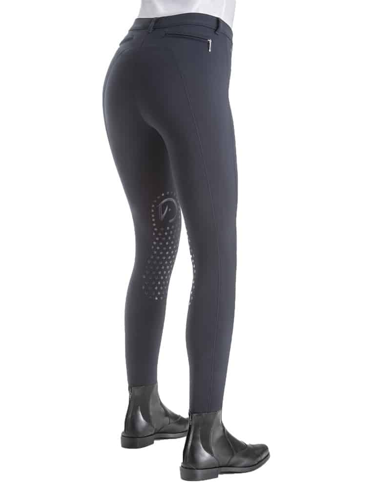 Rear view of navy blue riding breeches with silicone knee grip and black riding boots for equestrian use